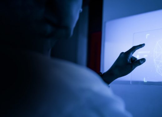 Designer using a transparent digital tablet screen futuristic technology